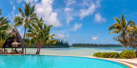 Infinity pool and palm trees, tropical beach, luxury travel resort in the Isle of Pines, New Caledonia