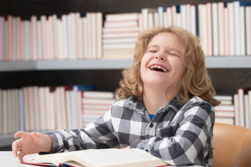 Kid reading a book in a school library. School boy education concept.