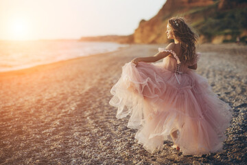 Beautiful woman in a dress by the sea.