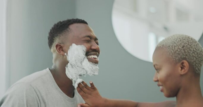 Skincare, beauty and black couple with shaving cream on face for wellness, cleaning and grooming in bathroom. Dating, love and black woman helping man with cosmetics, foam and facial creme for shave