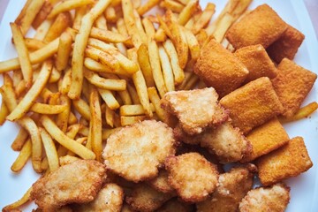 Fast food French fries and nuggets from different types of meat.