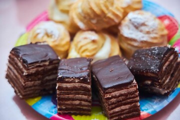 Pies and eclairs with custard on the festive table