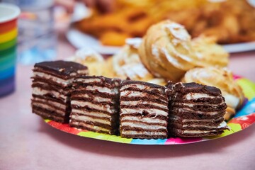 Pies and eclairs with custard on the festive table