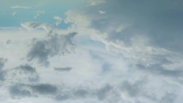 Beautiful Gray White Cumulus Clouds Float in Light Blue Sky TimeLapse. Aerial View Air Plane Window View, Drone Shooting. Beauty, Relax, High, Heaven, Blye Skyscraper and Puffy Clouds.