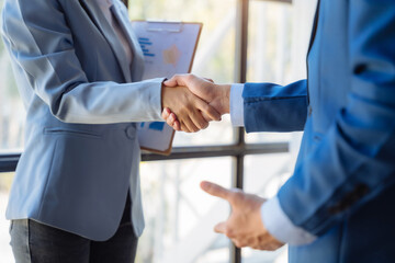 Fototapeta premium Business men and women shake hands confidently professional investor working with new startup project at an office meeting.
