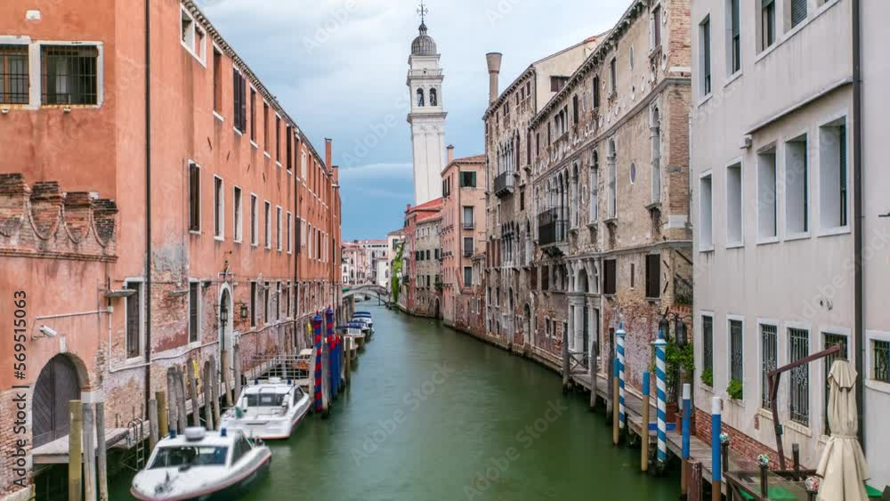 Wall mural venice timelapse: canal, bridge, boats and an old tower in the background. blue sky at summer day. g