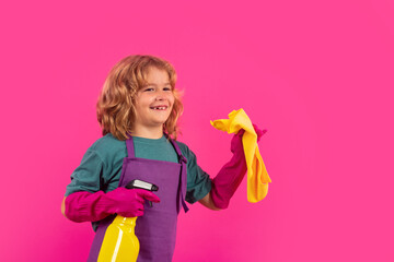 Studio portrait of child helping with housework, cleaning the house. Housekeeping, home chores.