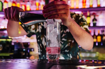 man bartender making cold gin tonic cocktail in bar