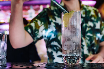 man bartender making cold gin tonic cocktail in bar