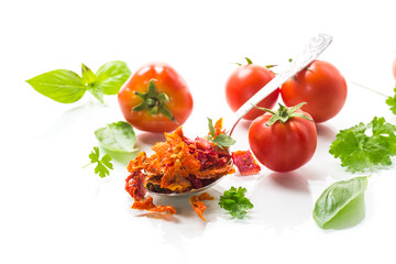 small pieces of dried tomatoes next to fresh tomatoes