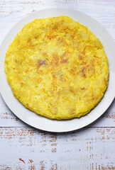 Homemade potato and onion omelet, typical of Spain.
Vertical shot and zenith view.