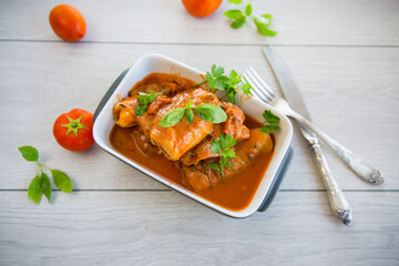 Traditional stuffed cabbage with minced meat and rice, served in a tomato sauce.