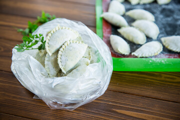 Raw green dough dumplings with parsley, dill.