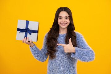Emotional teenager child hold gift on birthday. Funny kid girl holding gift boxes celebrating happy New Year or Christmas. Happy teenager, positive and smiling emotions of teen girl.