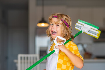 Child use duster and gloves for cleaning. Funny child mopping house. Cleaning accessory, cleaning...