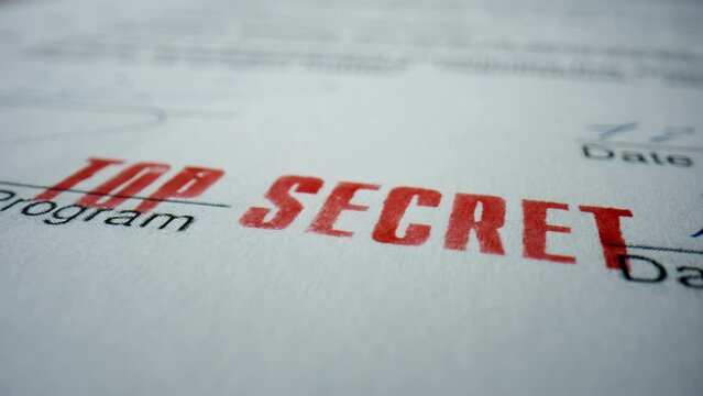 Closeup sign top secret on private document. Red prohibition stamp on text.