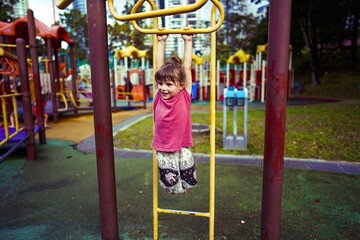child in kuala lumpur malaysia on the playground twin towers 