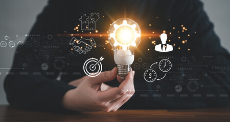 Innovation design concept. Hand holding light bulb for business creative inspiration.