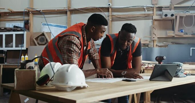 Two African supervisors working and discussing new deigns in the factory