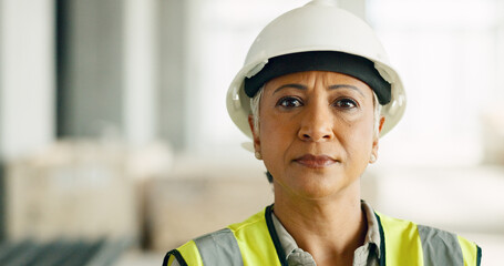 Woman, serious face and construction worker, engineer at work site and business, building trade industry portrait. Mature person, safety helmet and professional, engineering and construction job.