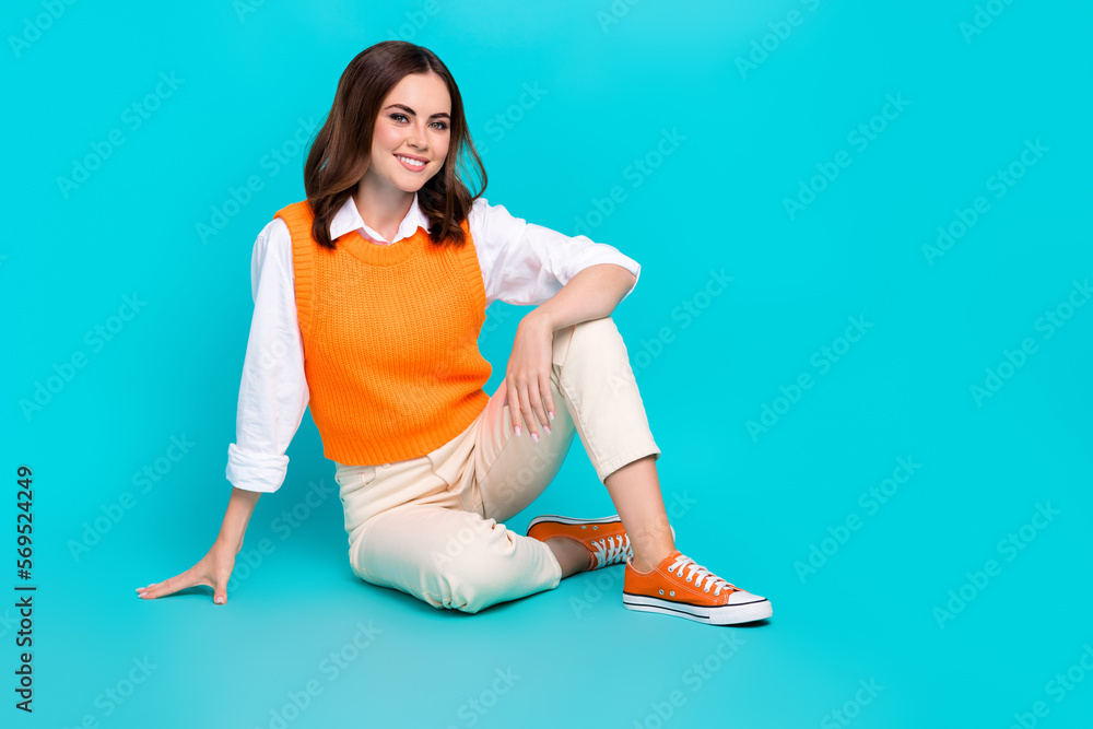 Wall mural full length size photo of satisfied lady sit wear white pants orange vest stylish sneakers enjoy sea