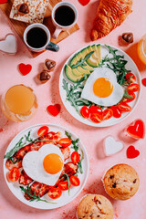 Couple breakfast on Valentines Day on pink background, top view