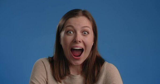 Woman is super exited, woman's emotions on chroma key blue screen, 4k 60p Prores