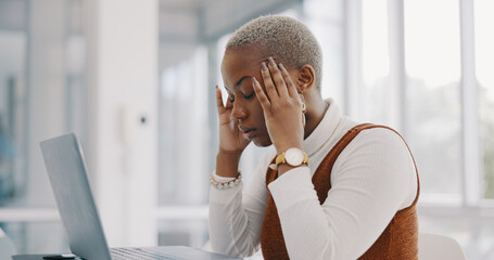 Stress, burnout and headache of black woman on laptop typing email in office at marketing company....