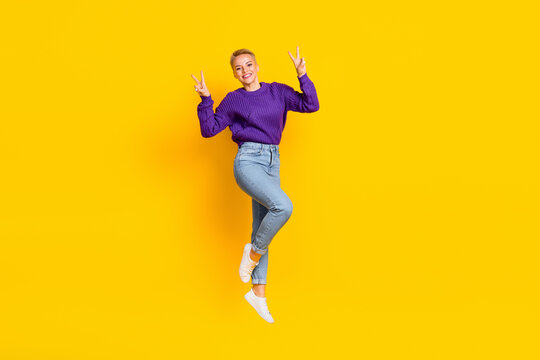 Full Length Portrait Of Overjoyed Friendly Person Jumping Demonstrate V-sign Isolated On Yellow Color Background