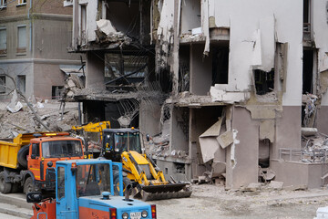 Workers clear rubble after bombing. Dwelling house damaged by russian missile