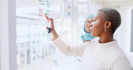 Teamwork, business people and leadership of black woman with sticky note in office workplace....