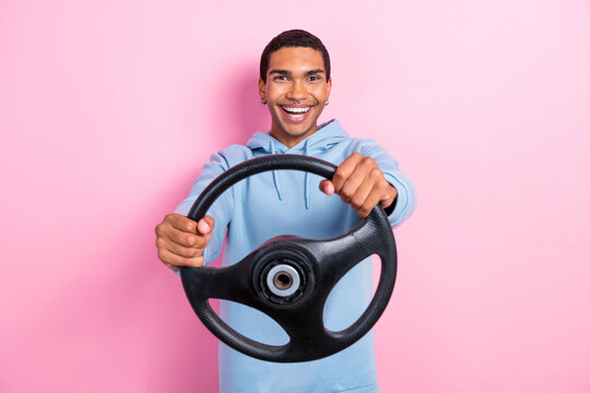 Photo of funny fast speed driving man hold steering wheel enjoy his new car automobile got final license test isolated on pink color background