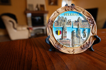 Belgium souvenir plate on a stand at home.