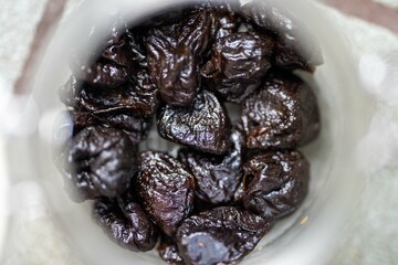 dried fruit, dates, prunes, grains, wheat, lentils, rice stored in glass jars in a kitchen