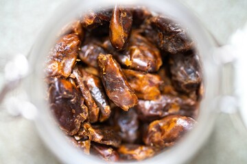 dried fruit, dates, prunes, grains, wheat, lentils, rice stored in glass jars in a kitchen