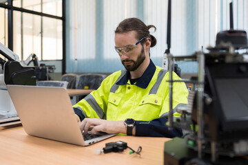 Male engineer using laptop computer for training Programmable logic controller. Male programmer...