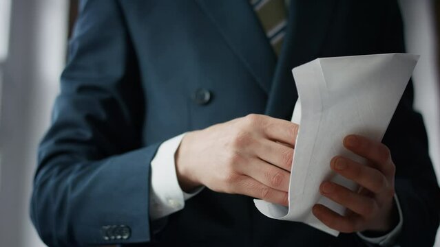 Businessman taking euro envelope indoors close up. Manager received bribe.