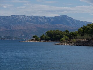 view from the sea with the mainland of Split and the mountains behind 