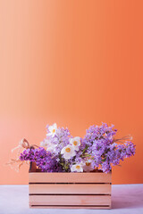 Blank greeting card with spring, Mother's Day or March 8. Lilac and anemones flower bouquet in wooden box