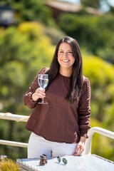 beautiful lady on a balcony having a drink in hobart australia