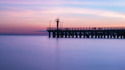Fototapeta na wymiar Pier by the Black Sea in the evening on a long exposure