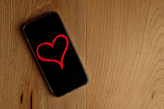 mobile phone with a photo of a heart on the screen