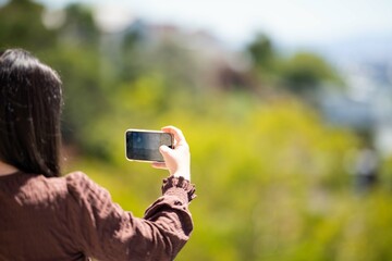 Girl taking a selfie on holiday in australia. Business Woman taking a phone photo of herself on a trip