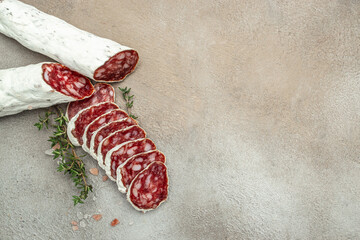 Traditional Spanish Fuet dried sausage on a light background. banner, menu, recipe place for text, top view