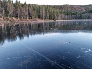 reflections on the water of a frozen lake
