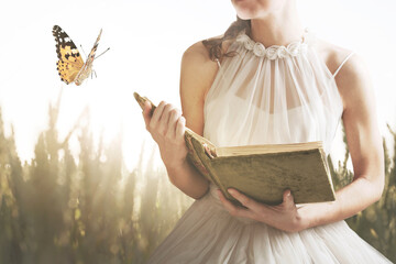 surreal encounter in a meadow between a woman reading a book and a butterfly, abstract concept