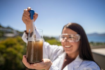 Soil test, female agricultural scientist conducting a soil test in a scientific lab in. soil...
