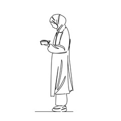 muslim girl reading a book standing