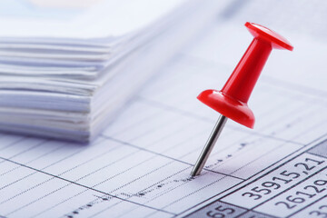 Marking financial chart by pins.Share listing and checking financial chart. Concept of banking, financial report and financial audit.