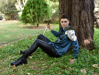 Close up portrait of handsome brunette male model wearing fantasy medieval prince costume, romantic...